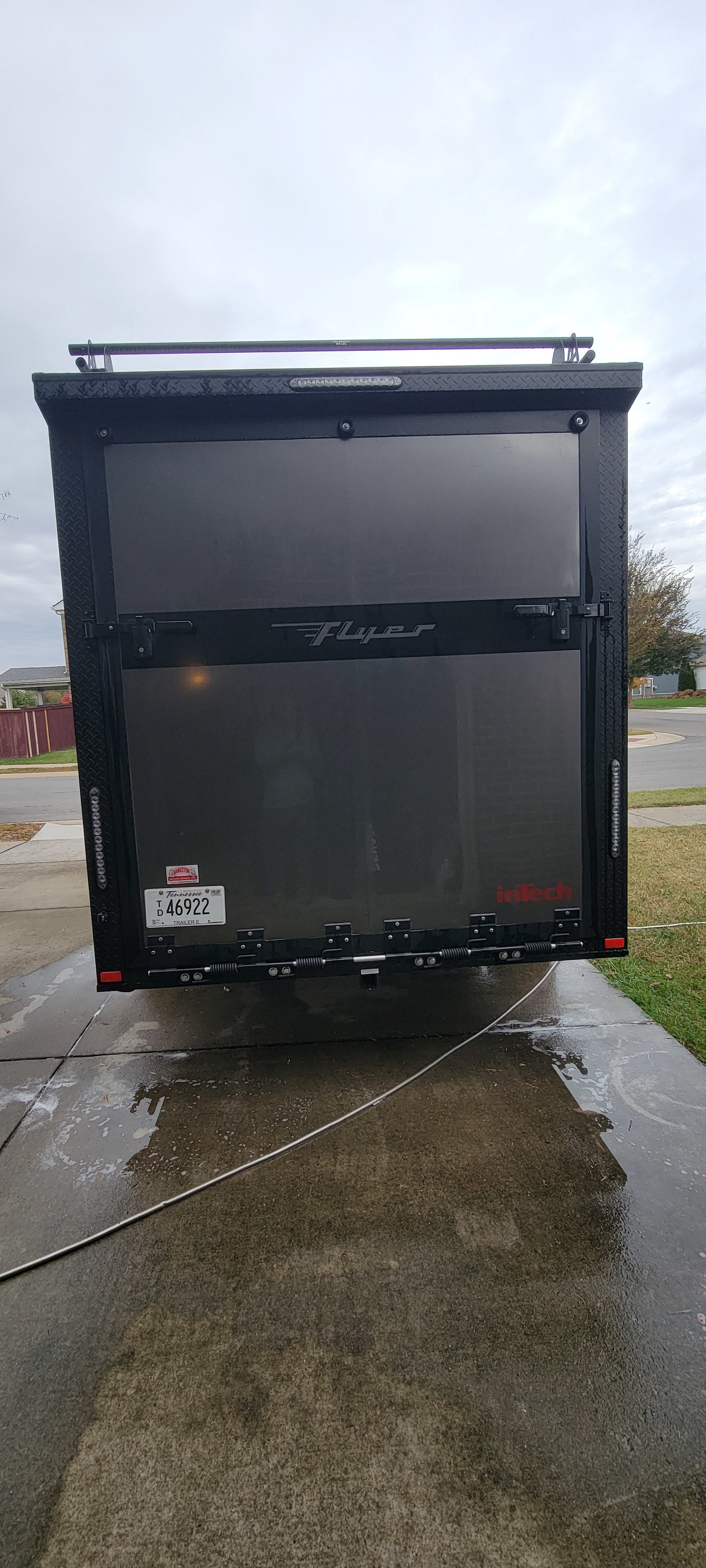 Rear of a dark gray "Flyer" inTech enclosed trailer with Tennessee plate TD 46922. Perfect for your rv rental adventure!