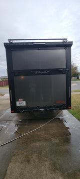 Rear of a dark gray "Flyer" inTech enclosed trailer with Tennessee plate TD 46922. Perfect for your rv rental adventure!