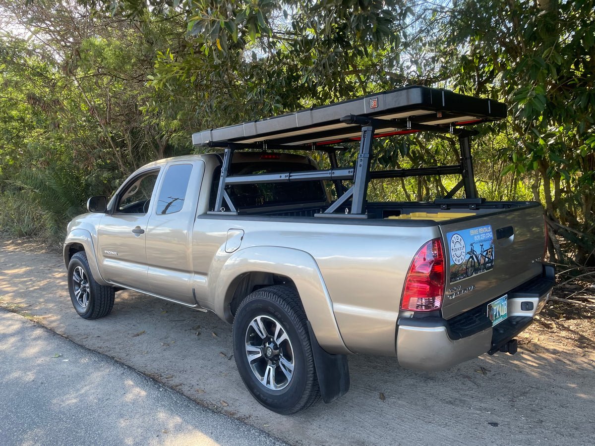 Tan Toyota Tacoma pickup with adventure gear and bike rentals sign. A versatile alternative to an RV rental for exploration. — photo 19