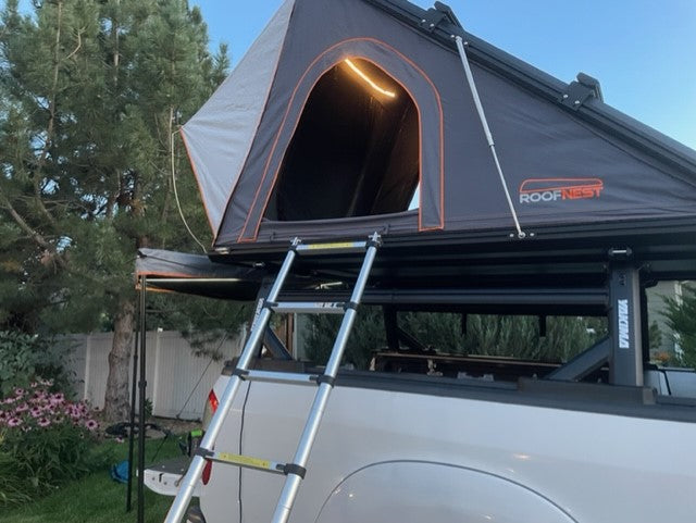 Illuminated Roofnest rooftop tent on a truck, an excellent alternative to RV rental for cozy camping and overlanding adventures. — photo 8