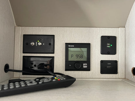 An RV rental's utility panel: Winegard TV, Truma control, USB charging, and HDMI ports for entertainment and convenience.
