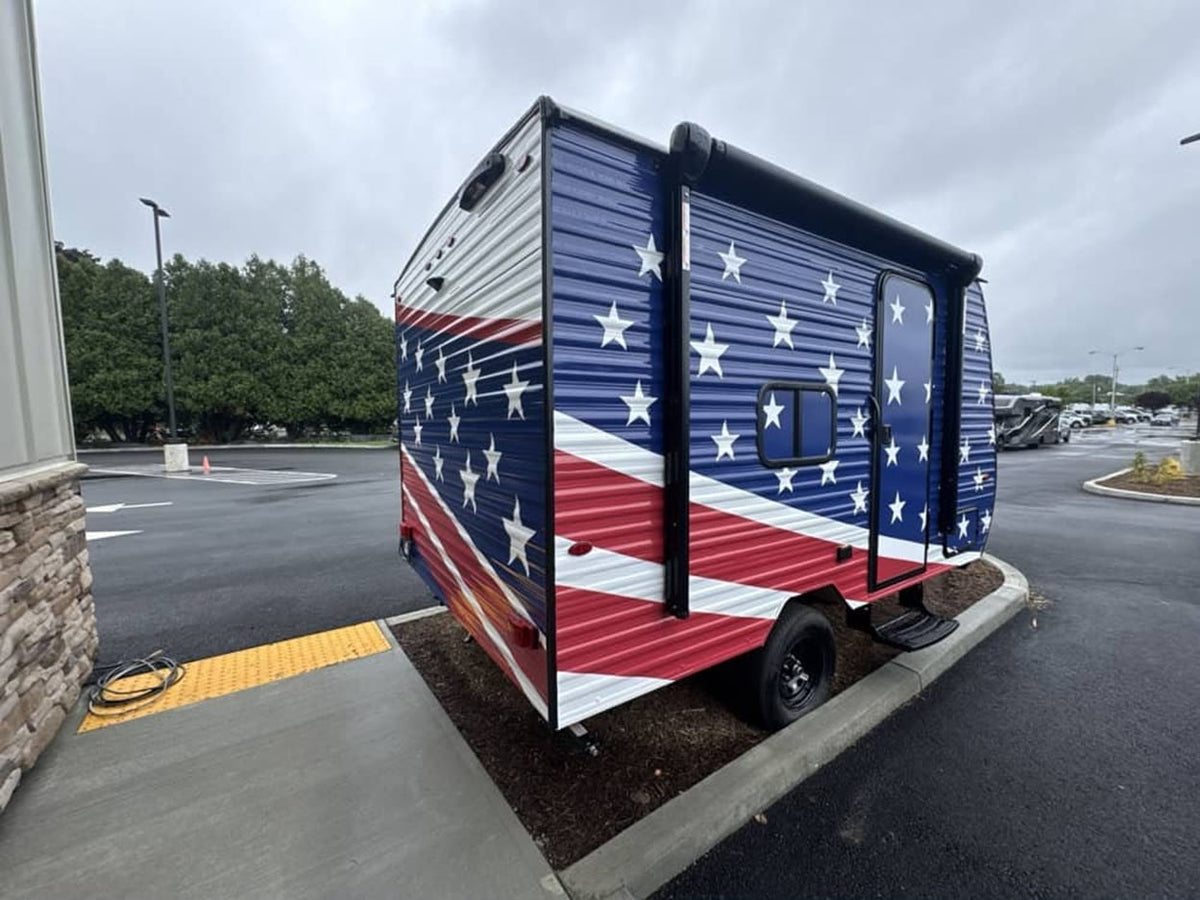 Bold American flag design on this RV rental camper trailer