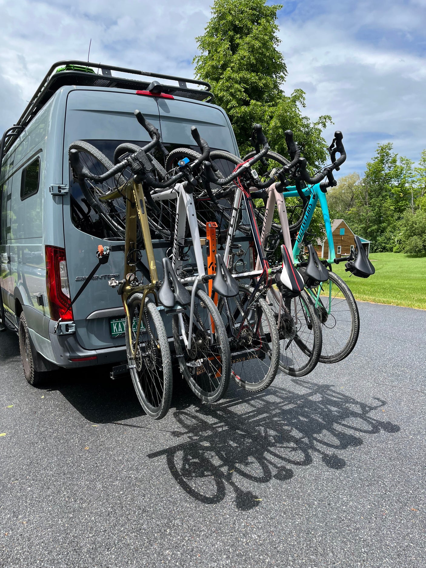 Grey Sprinter van, ideal for rv rental, with five bikes on a rear rack & roof rack. Ready for your next cycling adventure.