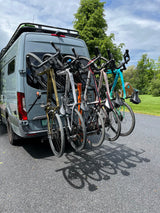 Grey Sprinter van, ideal for rv rental, with five bikes on a rear rack & roof rack. Ready for your next cycling adventure.