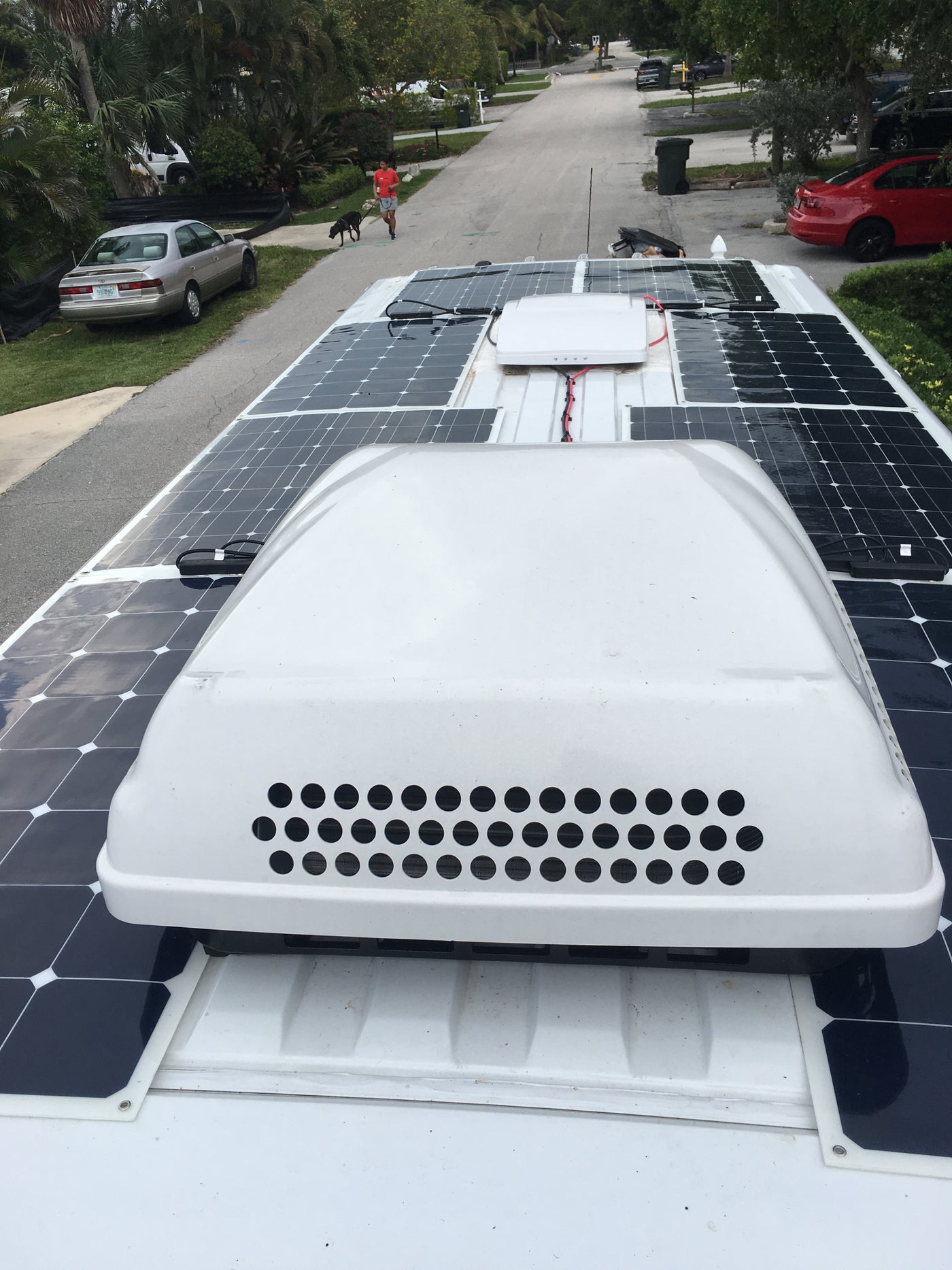 Multiple solar panels and an AC unit top this RV rental, providing off-grid power for adventures. — photo 6