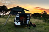 Relax and unwind with an rv rental. This compact camper, complete with a rooftop tent and outdoor kitchen, offers stunning sunset views.