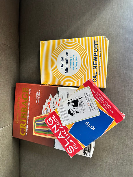 Unplug with Cal Newport's book & games like Cribbage and Slang Flashcards, ideal for your next rv rental getaway.