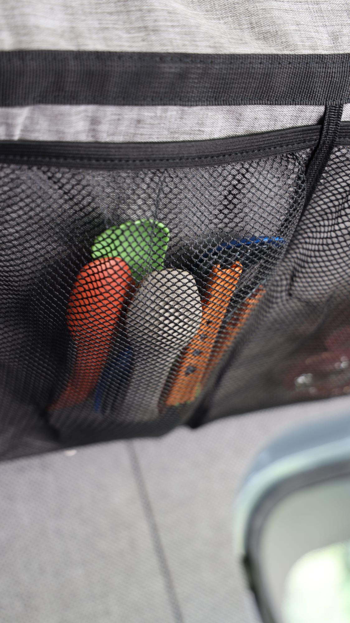 Organized rv rental travel: colorful utensils stored in a mesh pocket for easy access.