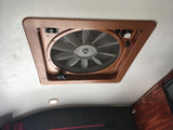 RV rental: Ceiling fan with screen on a textured white ceiling. Controls for airflow direction (in/out), speed, and lid.