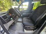 RV rental van interior. View of driver's area & passenger seat, steering wheel, dash, & 'DIESEL FUEL ONLY' sticker.