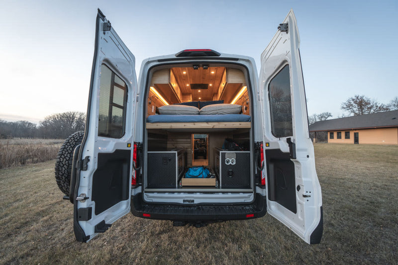  showcases its cozy wood interior through an open side door. Ready for adventure!|Experience a luxury RV rental interior: wood-paneled walls — photo 19