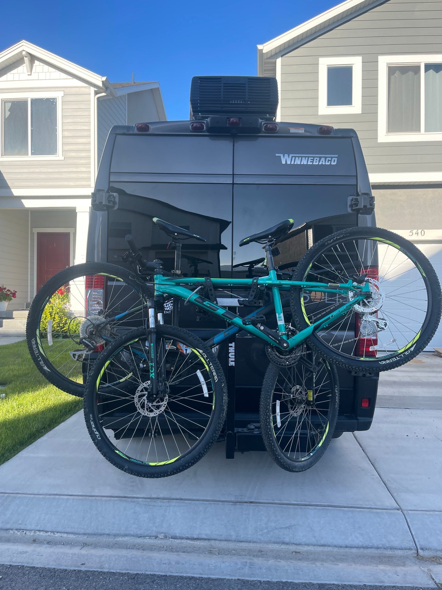 Winnebago RV rental van with Thule bike rack and two bikes, ready for adventure.