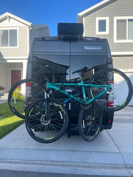 Winnebago RV rental van with Thule bike rack and two bikes, ready for adventure.