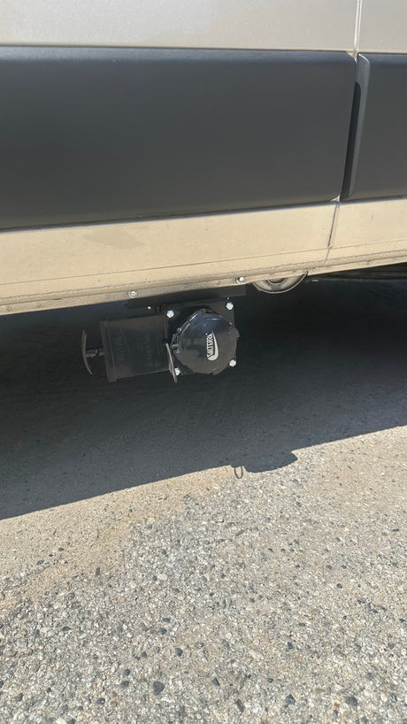 RV rental's undercarriage showing Valterra waste water dump valves, essential for sanitary disposal.