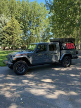 Explore off-road with this Jeep Gladiator rv rental, featuring a roof-top tent & fuel cans for your adventure camping!