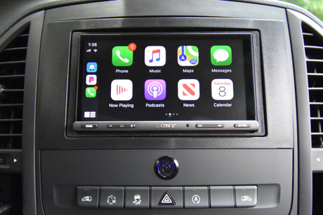 In-car Apple CarPlay infotainment in an RV rental, showing maps, music, & phone apps on a Sony unit; dashboard controls below.