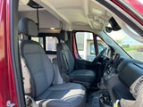 Interior of an RV rental, featuring the front cabin with driver and passenger seats, and dashboard.