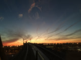 Gorgeous sunset over a city skyline from an elevated track. Perfect scenery for an RV rental trip or any travel adventure.