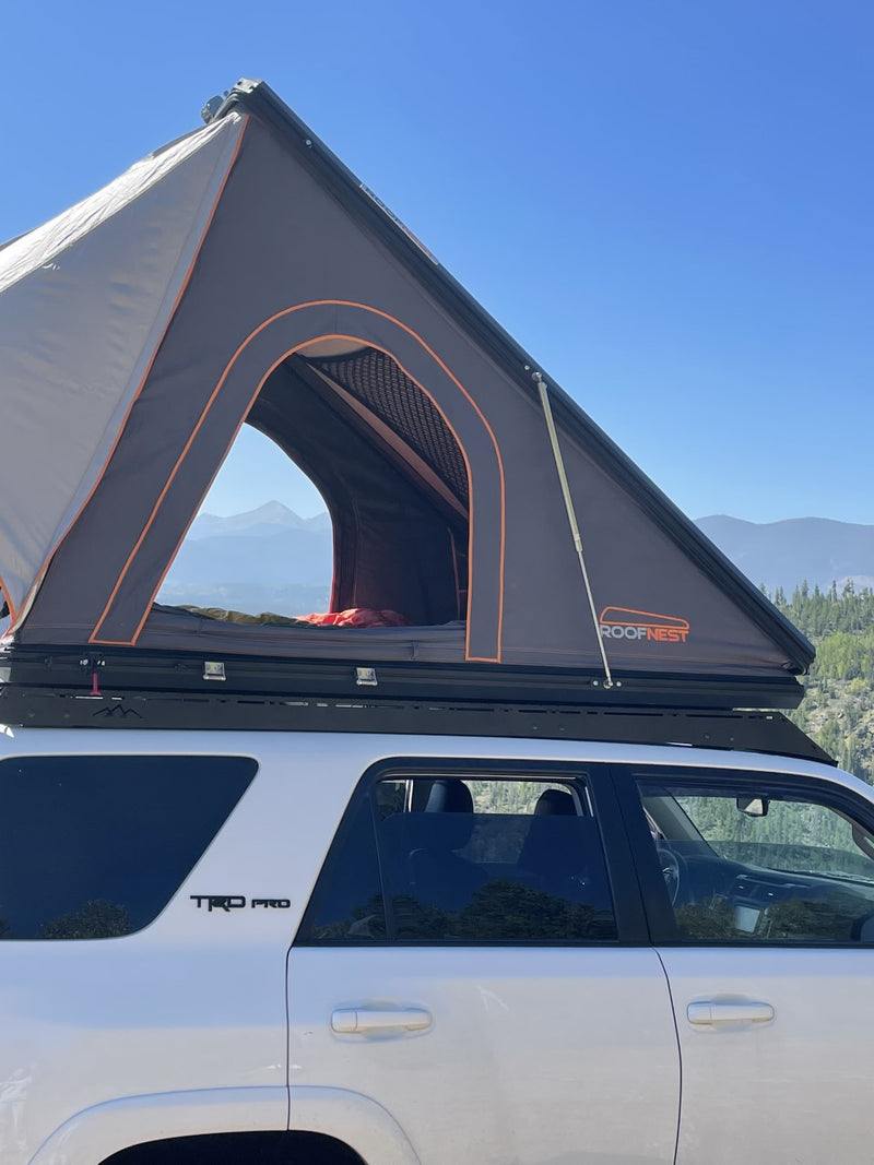 Experience camping freedom! This white 4Runner with a deployed Roofnest rooftop tent offers a unique RV rental alternative. — photo 9