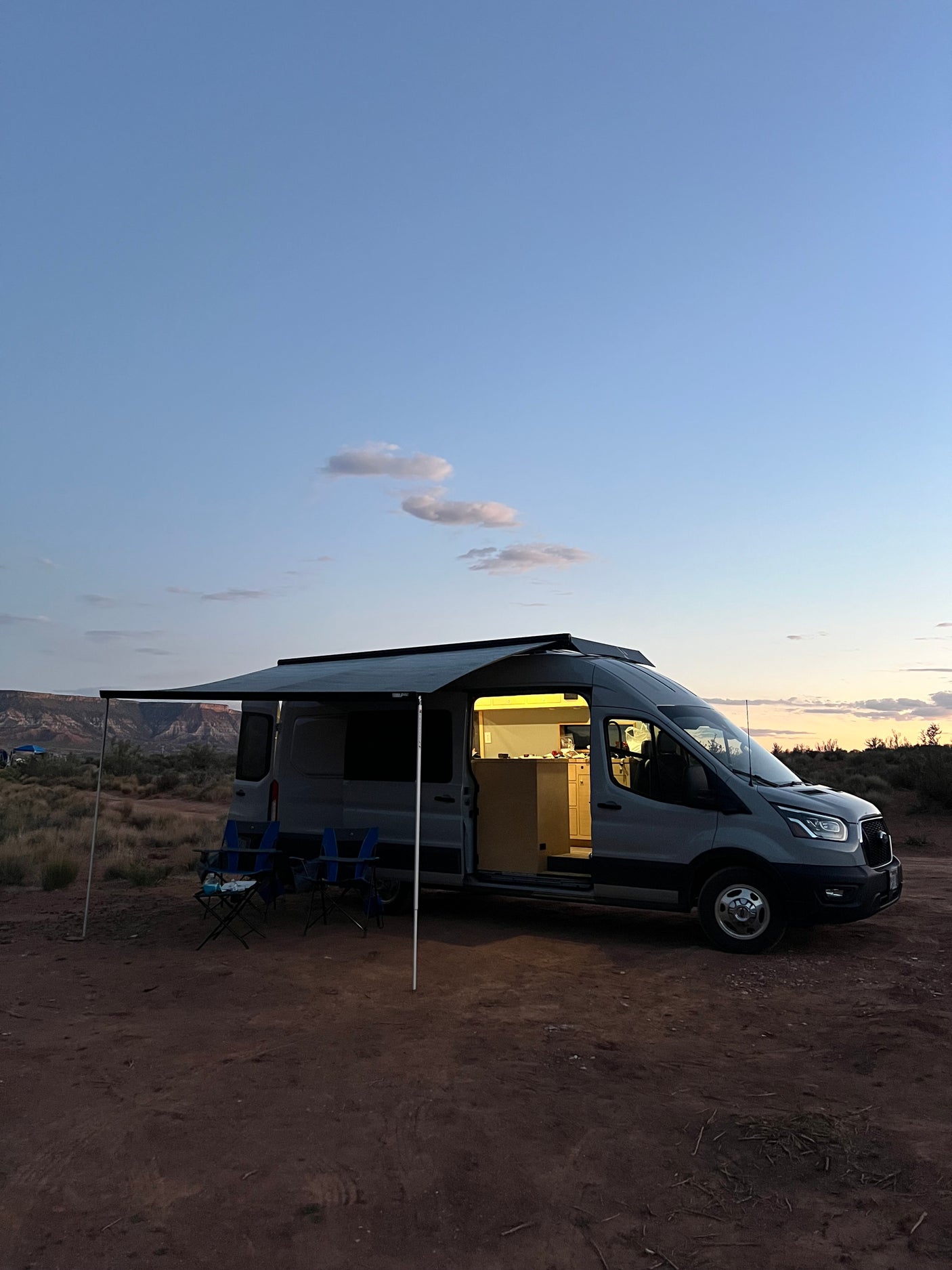 Relaxing campsite setup with an RV rental at sunset. Enjoy the open road and van life adventures.