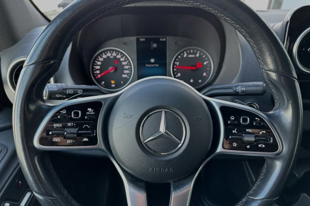 Inside a Mercedes-Benz RV rental: steering wheel, dashboard with "Reserve Fuel" warning. Controls visible.