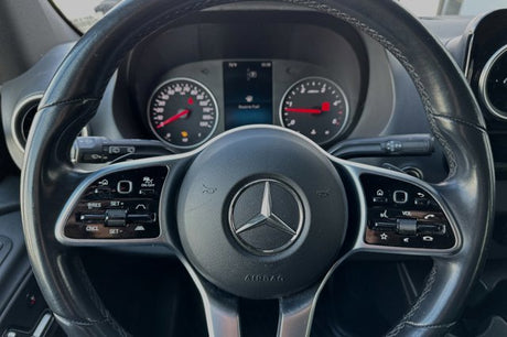 Inside a Mercedes-Benz RV rental: steering wheel, dashboard with "Reserve Fuel" warning. Controls visible.