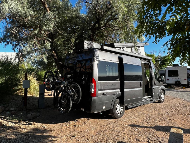  and a side awning.|Side view of a dark gray pop-top camper van for rv rental — photo 5