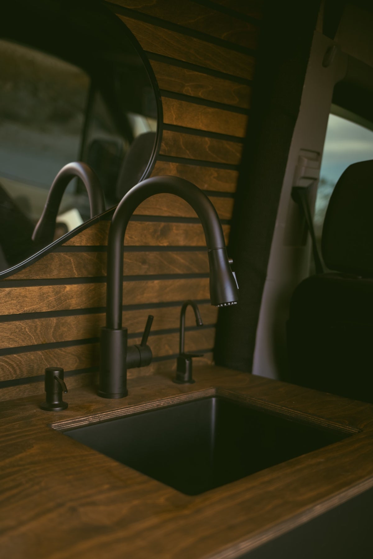  offering a stunning twilight desert view. Perfect for van life.|Cozy RV rental interior at night: a bed with a plush blanket — photo 10