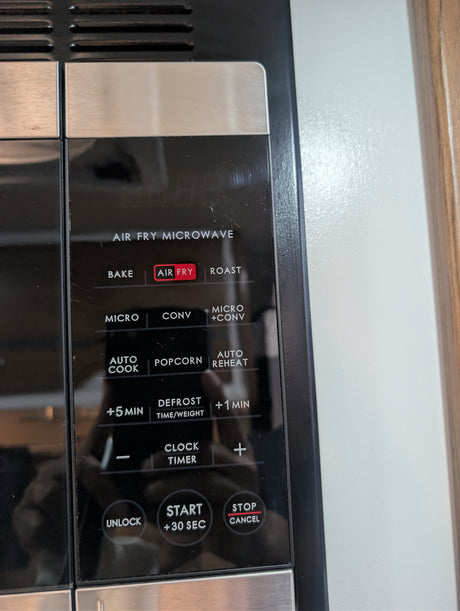RV rental kitchen: Air Fry Microwave control panel with "AIR FRY" highlighted, offering Bake, Roast, and Defrost options.