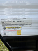 RV rental travel trailer specs: safety label with VIN, GVWR, tire size (ST235/75R15), and 65 PSI cold tire pressure details.