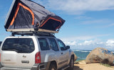 This unique RV rental, a silver SUV with a rooftop tent, offers beachfront camping. Explore outdoor adventures!