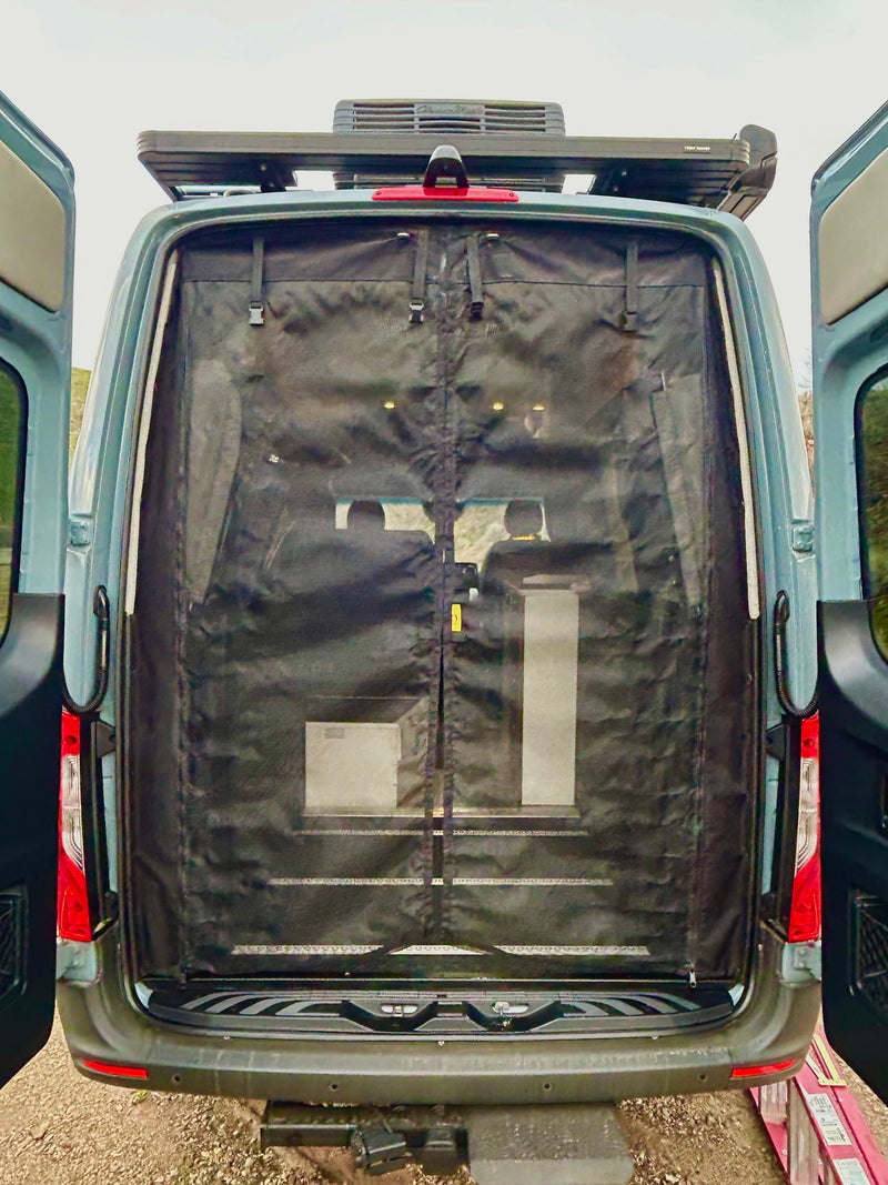Rear view of an RV rental van with open back doors & privacy screen. Notice the roof AC and racks. — photo 18