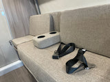 RV rental interior features comfortable bench seating, cupholders, and seatbelts, ready for safe travels.