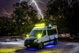 Adventure RV rental: Sprinter van with dazzling yellow and blue lights, ready for night exploration under a stormy, lightning-filled sky.