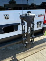 Rear view of a white Ram ProMaster rv rental van with a black Thule bike rack attached to the hitch.
