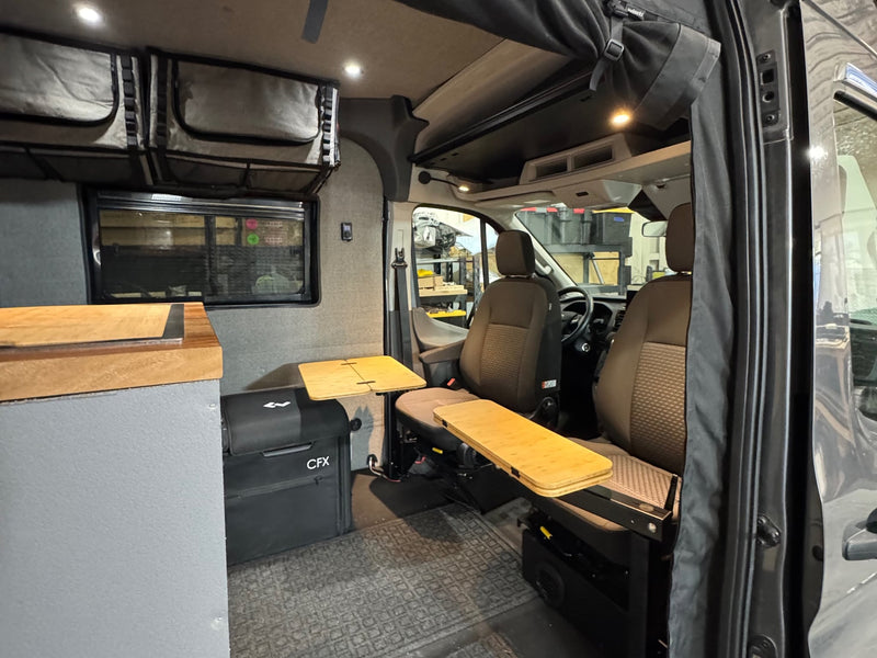  and outdoor camping setup with portable solar panels.|RV rental camper van interior: swivel seats — photo 5