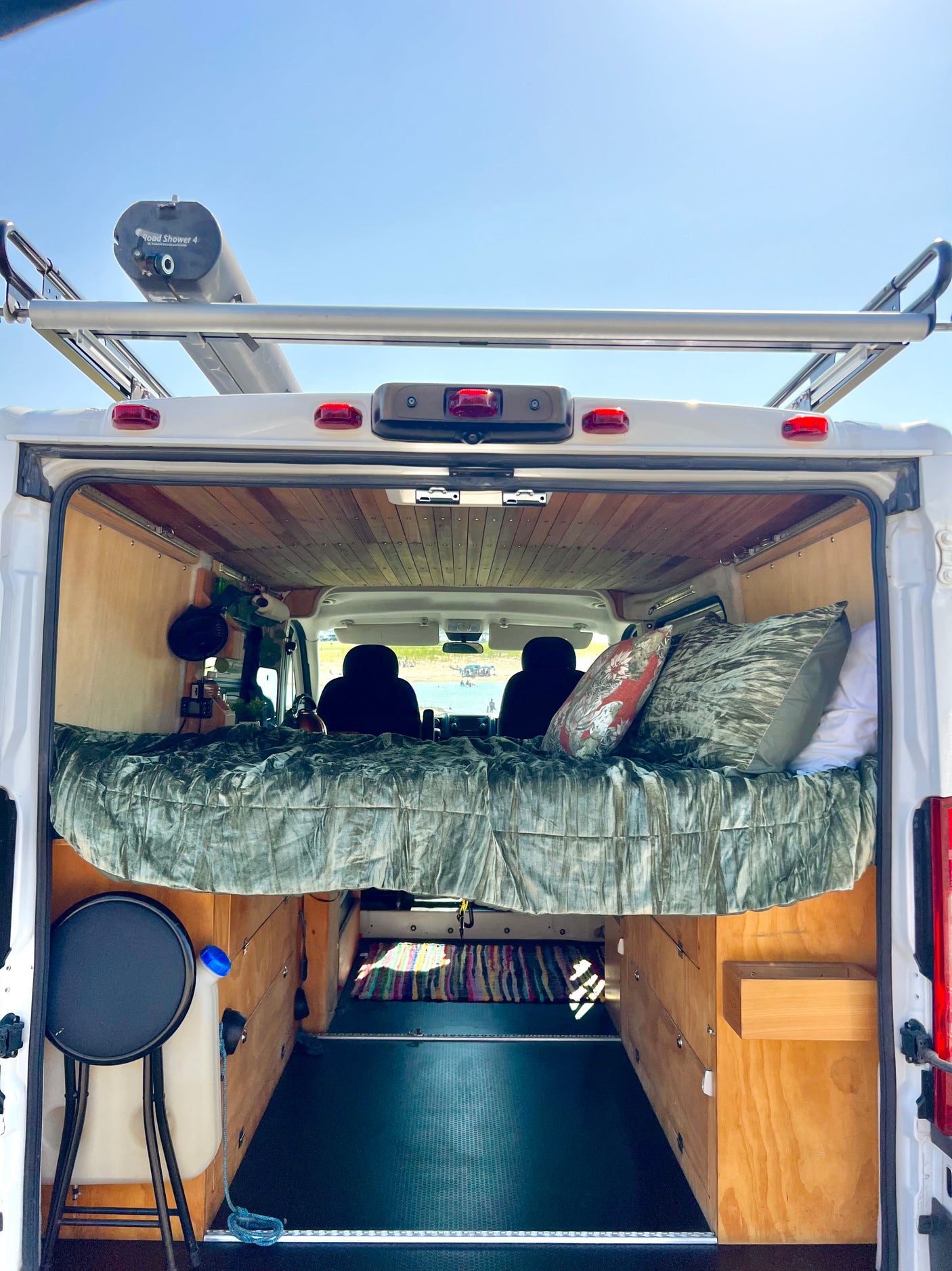 Experience van life! This RV rental features a cozy elevated bed, under-bed storage, and a roof shower for adventures.