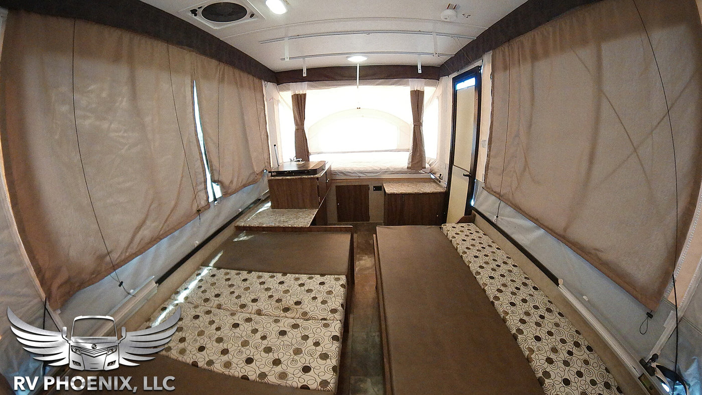 RV rental pop-up camper interior: featuring convertible beds, a small kitchen, and open living space for adventure. — photo 7