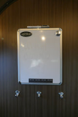 Whiteboard in an Airstream RV rental says "UTAH BOUND" with a marker & storage hooks, perfect for travel notes.