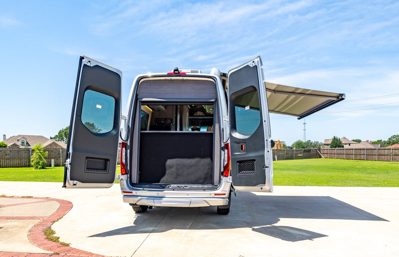  parked on a sunny driveway.|Silver Airstream Interstate RV rental parked on a sunny concrete driveway — photo 9