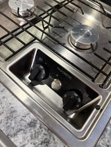 Stainless steel Dometic 2-burner RV rental stovetop with black grates, control knobs, and igniter button.