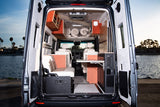 Spacious & comfortable RV rental: A well-appointed camper van interior with cozy seating, tables, and ample storage for any trip.