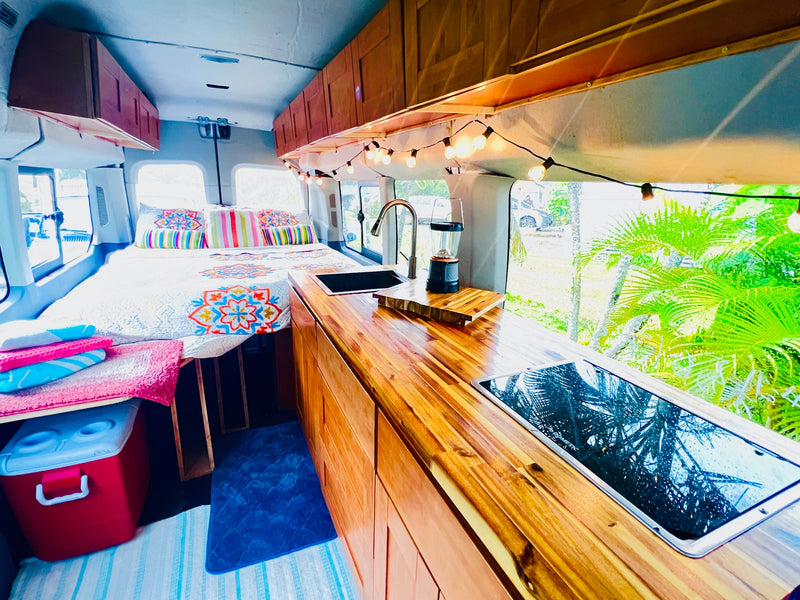 Explore this RV rental camper van interior: colorful bed — photo 1