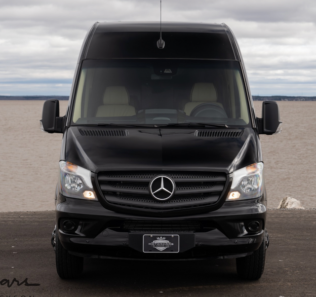 Front view of a sleek black Mercedes-Benz Sprinter conversion van, ideal for RV rental adventures.