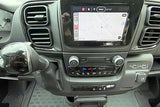 Modern rv rental dashboard with large navigation screen, dash-mounted gear shifter, climate, & charging ports.