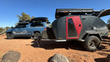 San Francisco Overland RV rental: blue pickup truck with rooftop tent and grey Escapod teardrop trailer.