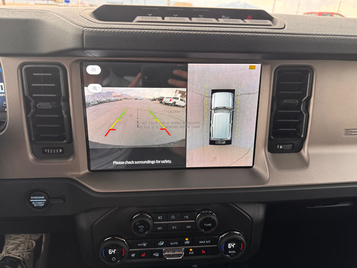  perfect for organized gear storage on an RV rental adventure.|Sunny view of a grey Ford Bronco. A covered RV rental is visible in the background — photo 13
