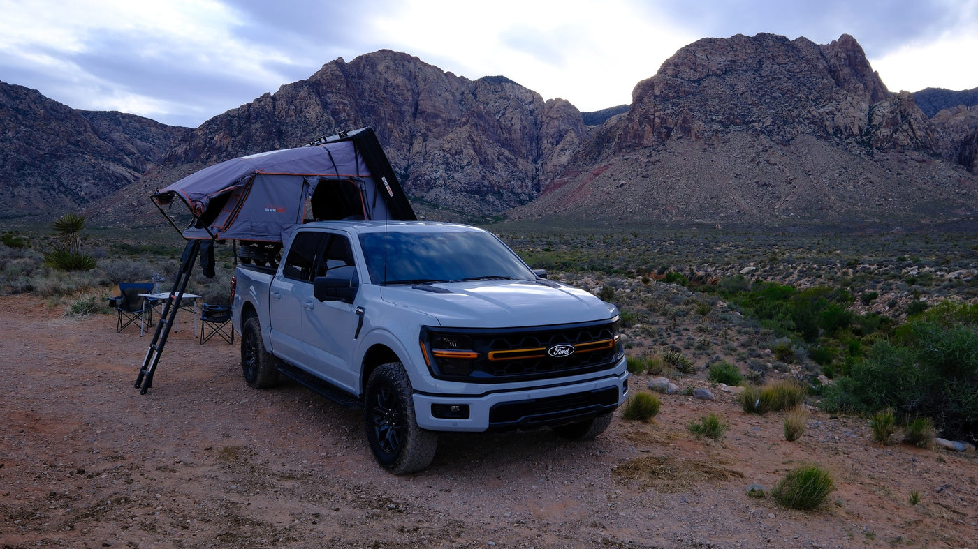 Overland Ford F-150 truck with a Roofnest tent parked in a rocky desert, ready for your next RV rental adventure. — photo 2
