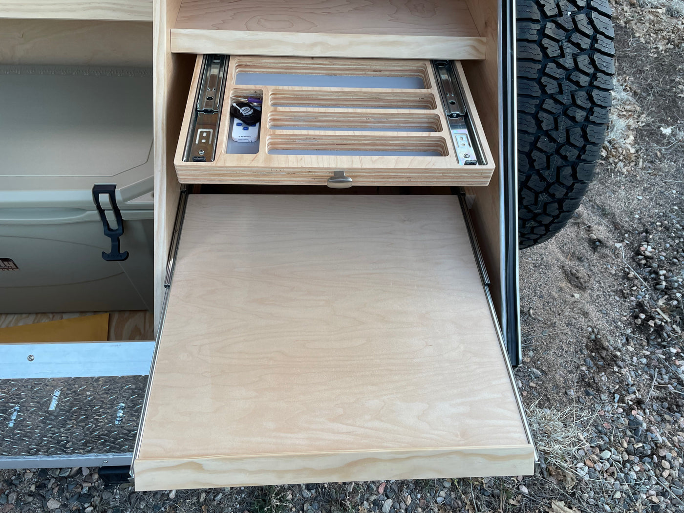 Explore this RV rental's clever storage, including an organized pull-out drawer, slide-out counter, and cooler. — photo 7