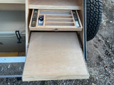 Explore this RV rental's clever storage, including an organized pull-out drawer, slide-out counter, and cooler.